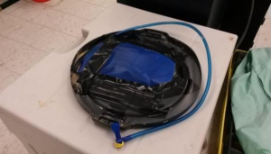 Fig. 3. Air bladder with metal weights underneath taped to a plastic lid.