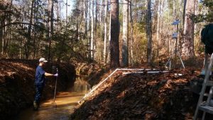 DOE Fellow Juan Morales installing a remote monitoring stations at SRS