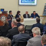 4 people seated in a table having a conversation
