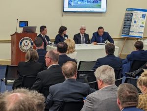 4 people seated in a table having a conversation