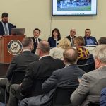 4 people seated at the table looking at the speaker
