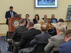 4 people seated at the table looking at the speaker