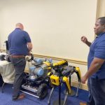 2 men manipulating robotic instruments