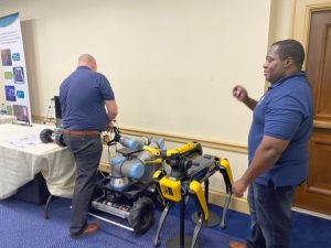 2 men manipulating robotic instruments