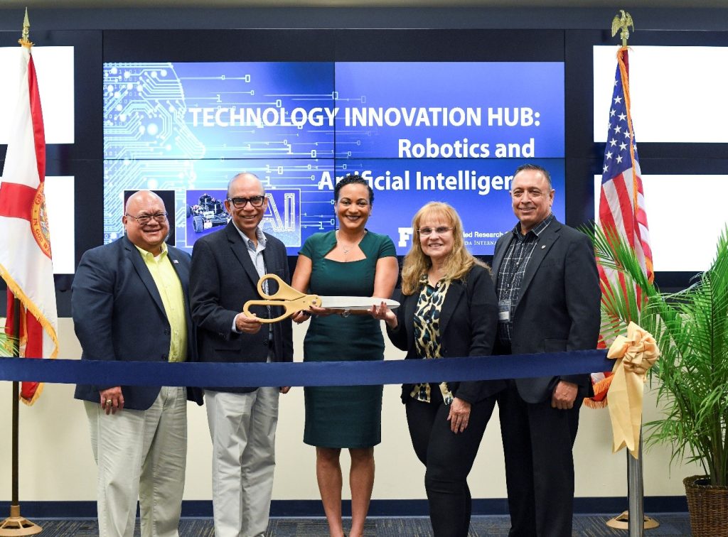 Ribbon Cutting Ceremony - Left to right: Rod Rimando (DOE-EM), Dr. Himanshu Upadhyay (Associate Professor Electrical Eng.), Dr. Heather Russell, FIU Office of the Provost), Dr. Ines Triay (Interim Dean, FIU College of Eng.), Dr. Leo Lagos (Director of Research – Applied Research Center, Associate Professor – Moss Department of Construction Management)